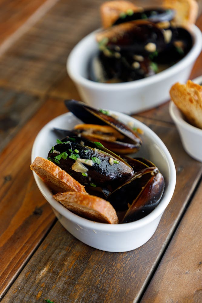 a bowl of food sitting on top of a wooden table
