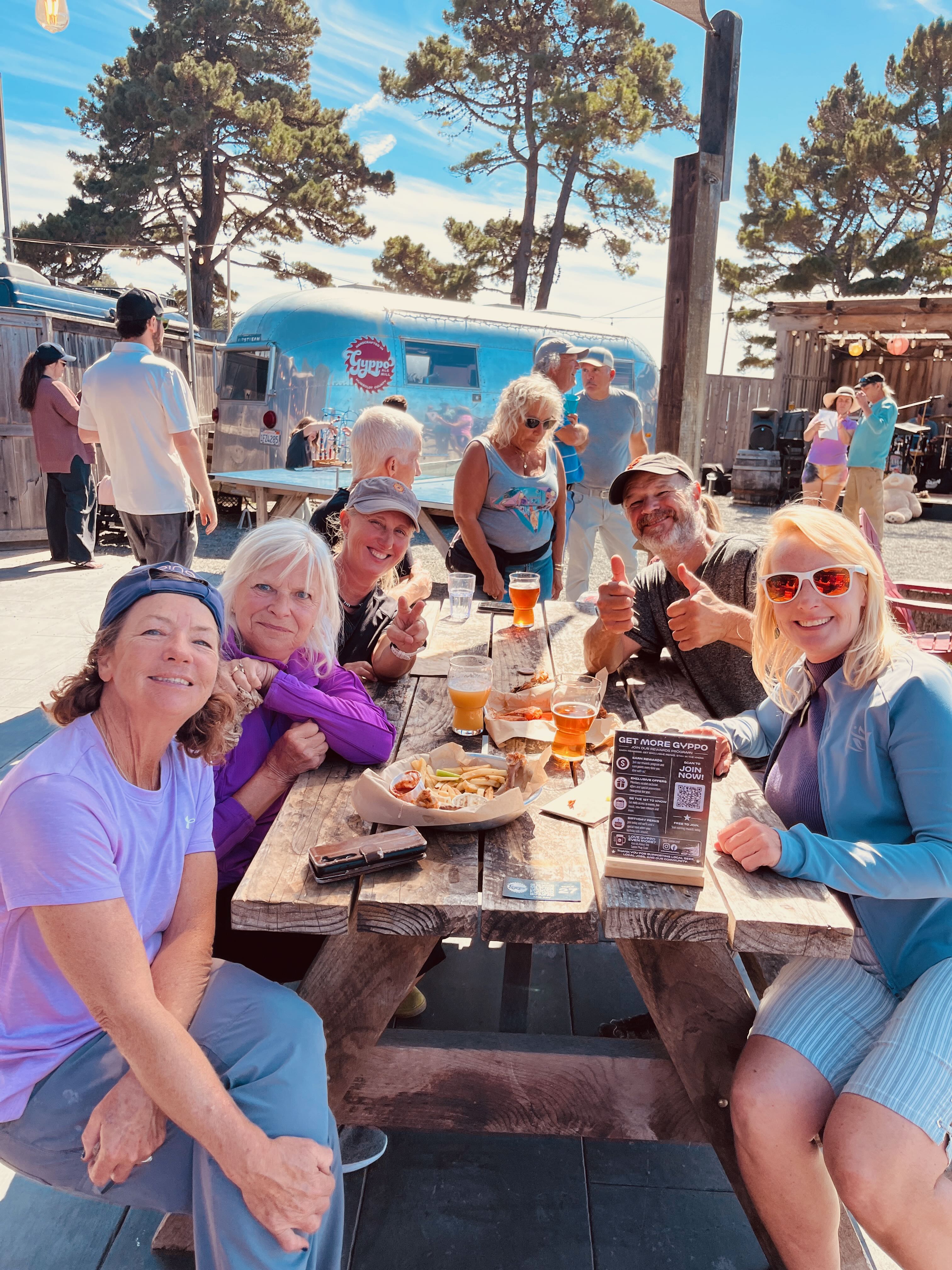 a group of people sitting at a picnic table