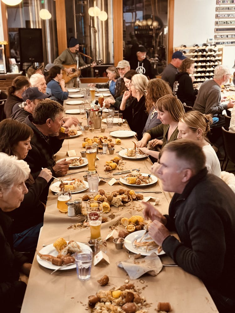 a group of people sitting at a table eating food