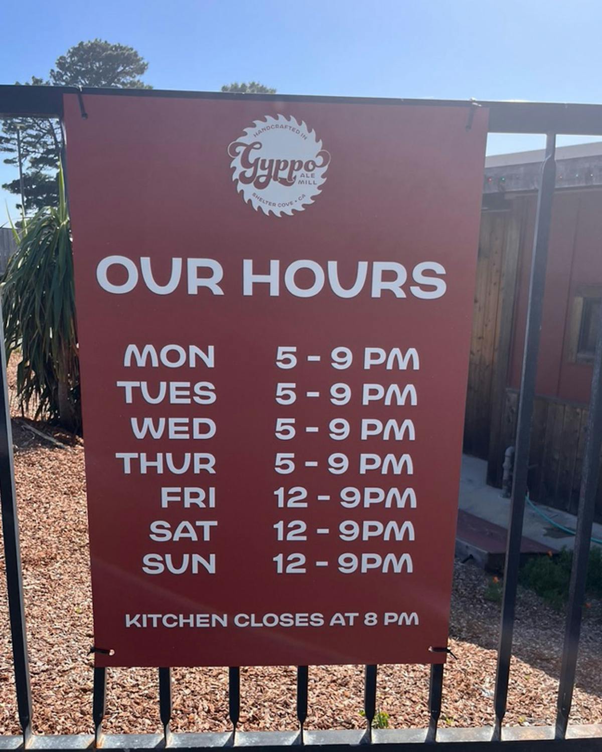 a sign on the side of a fence