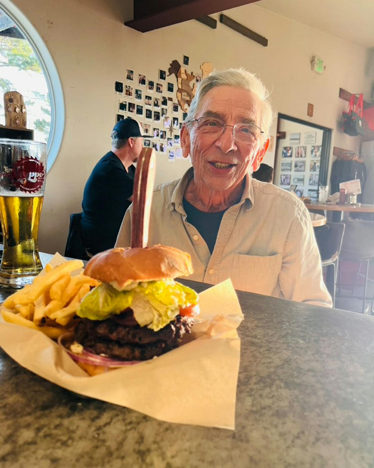a man holding a sandwich in a restaurant
