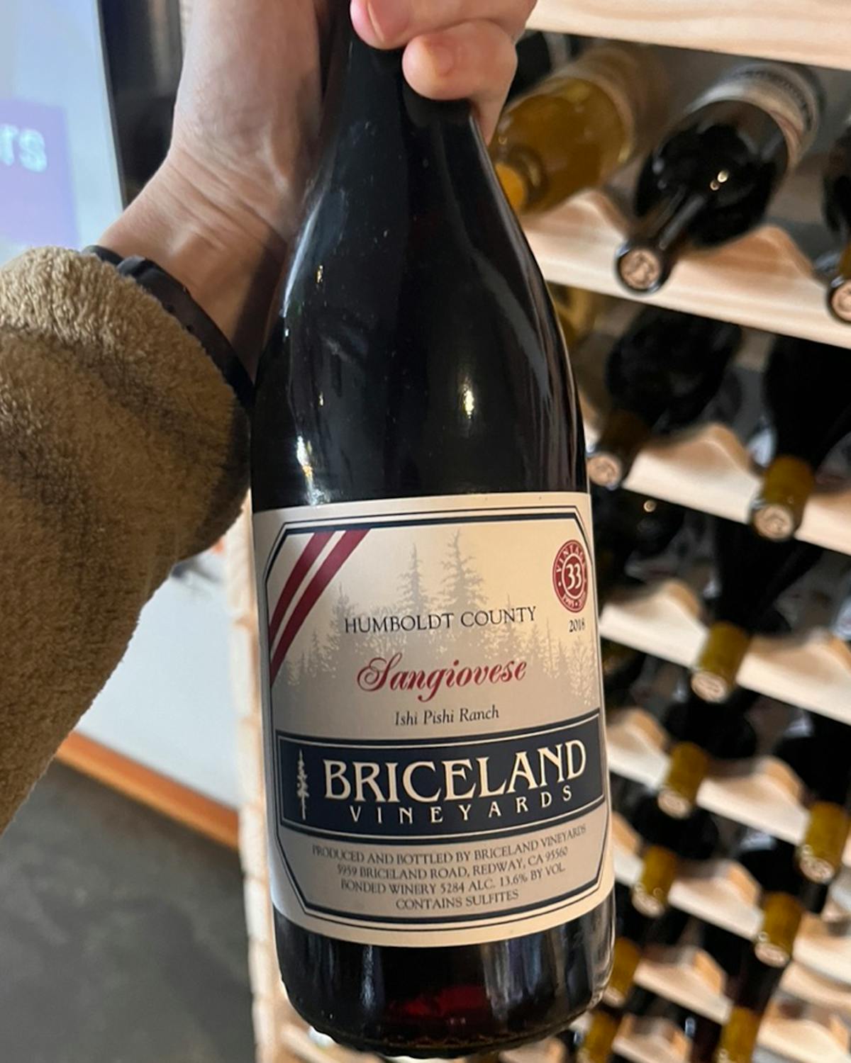 a person holding a bottle of wine