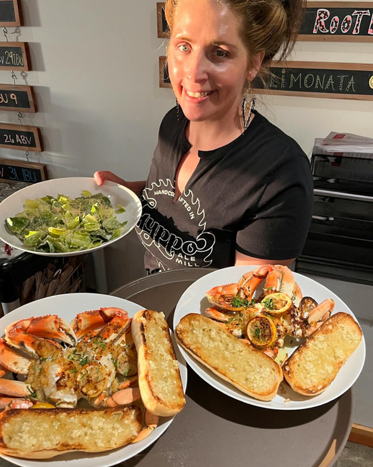 a person sitting at a table with a plate of food