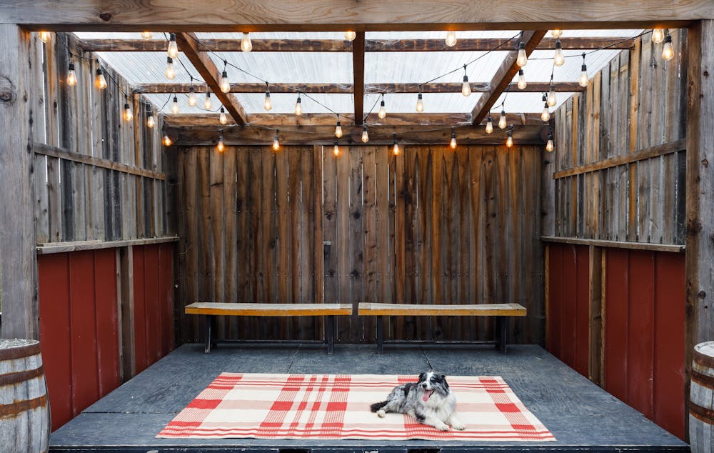 a train that is sitting on top of a wooden fence
