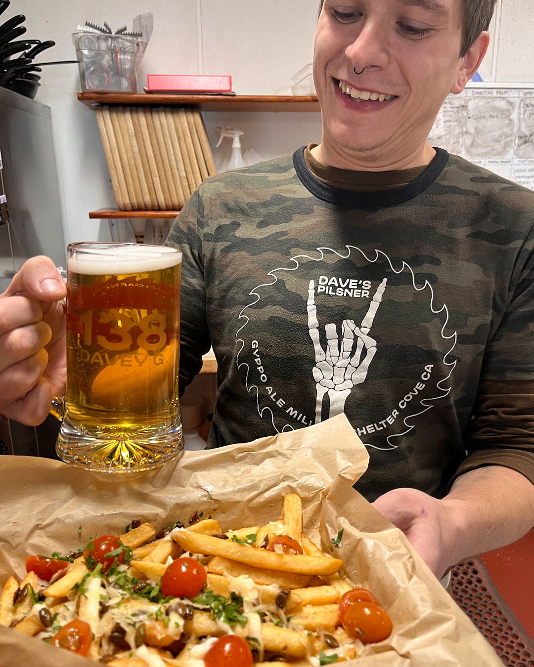 a person sitting at a table with a hot dog