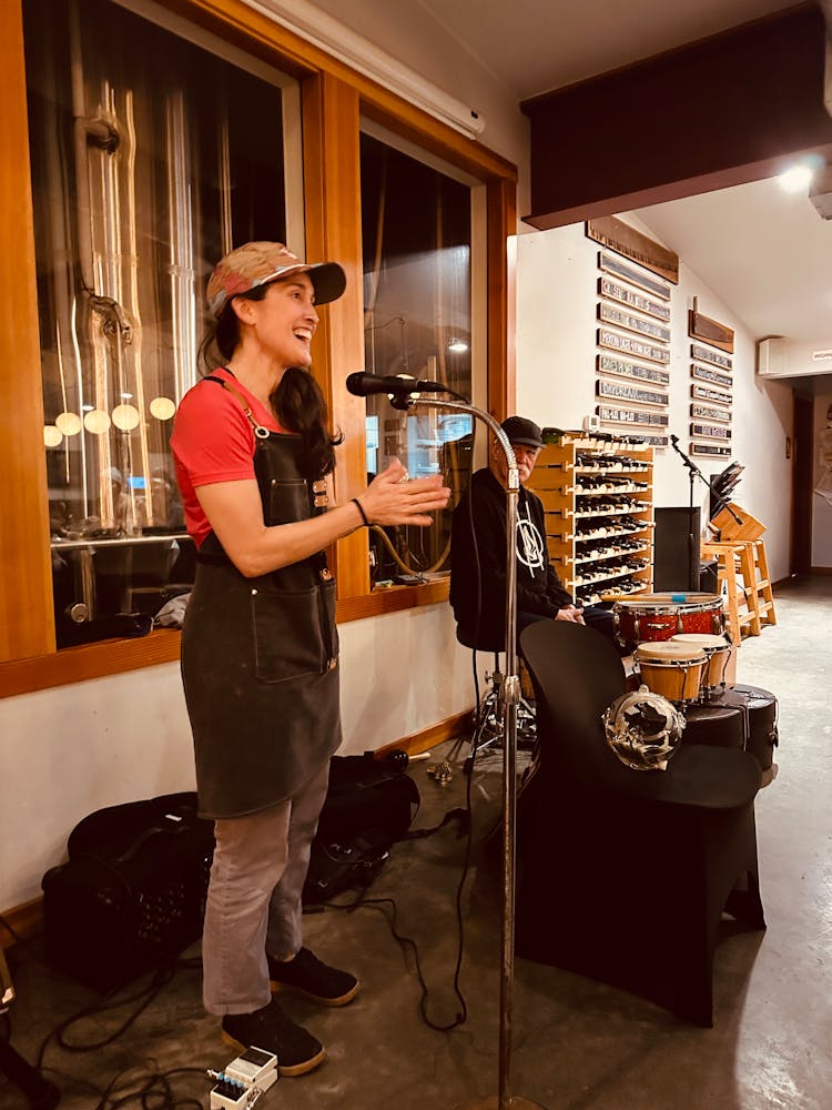 a woman standing in front of a microphone