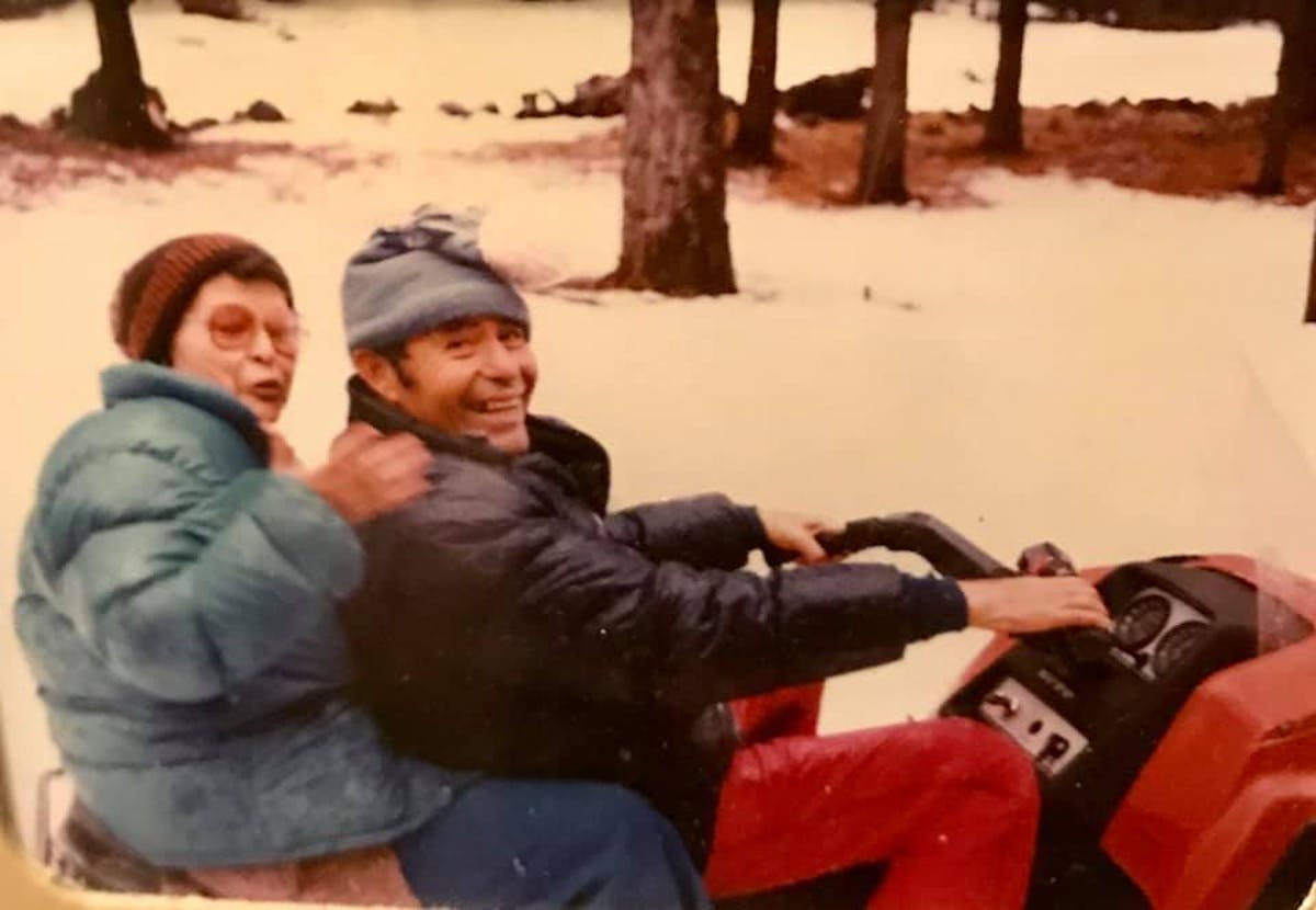 a group of people sitting in the snow