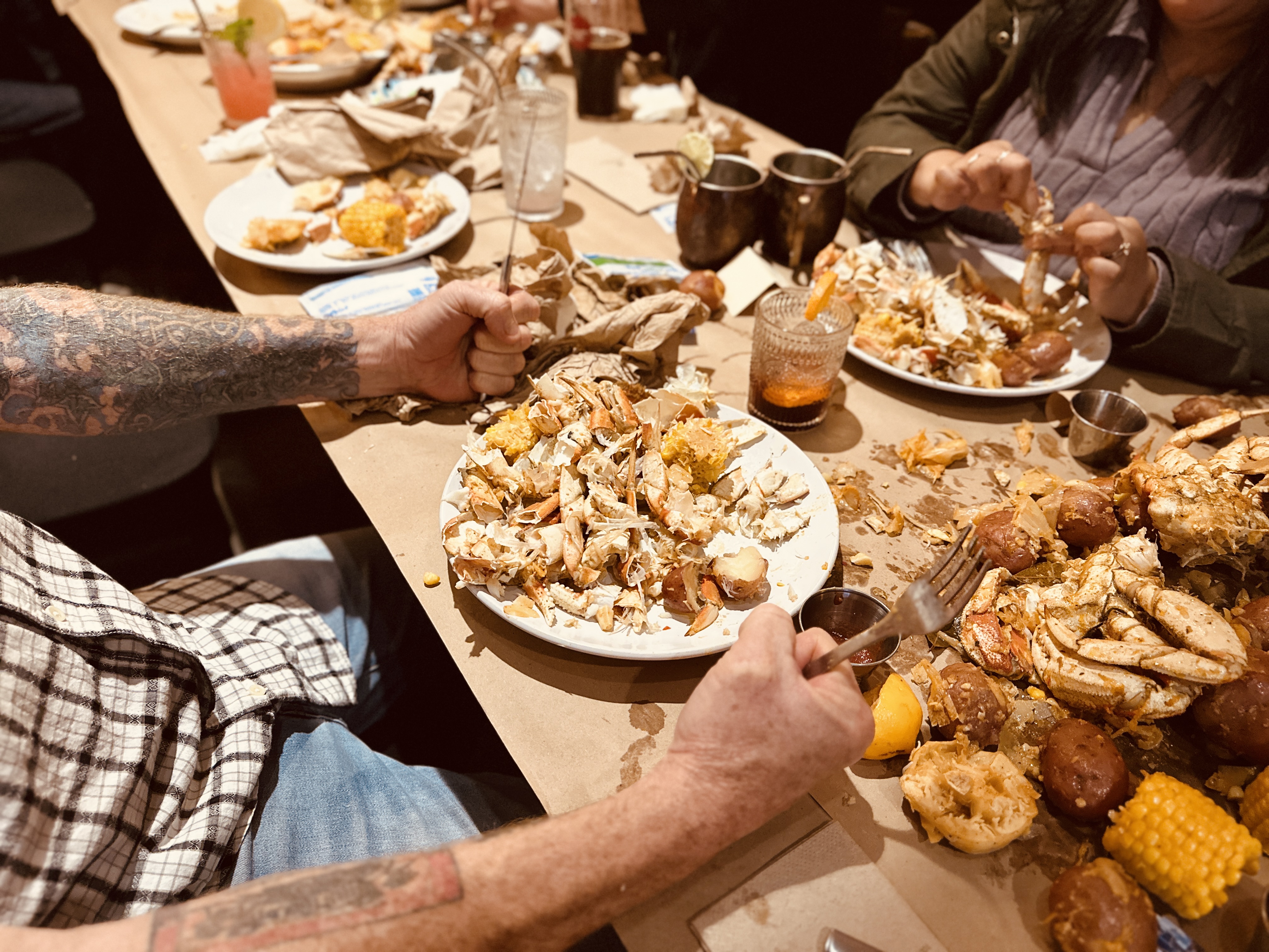 a group of people sitting at a table with a plate of food