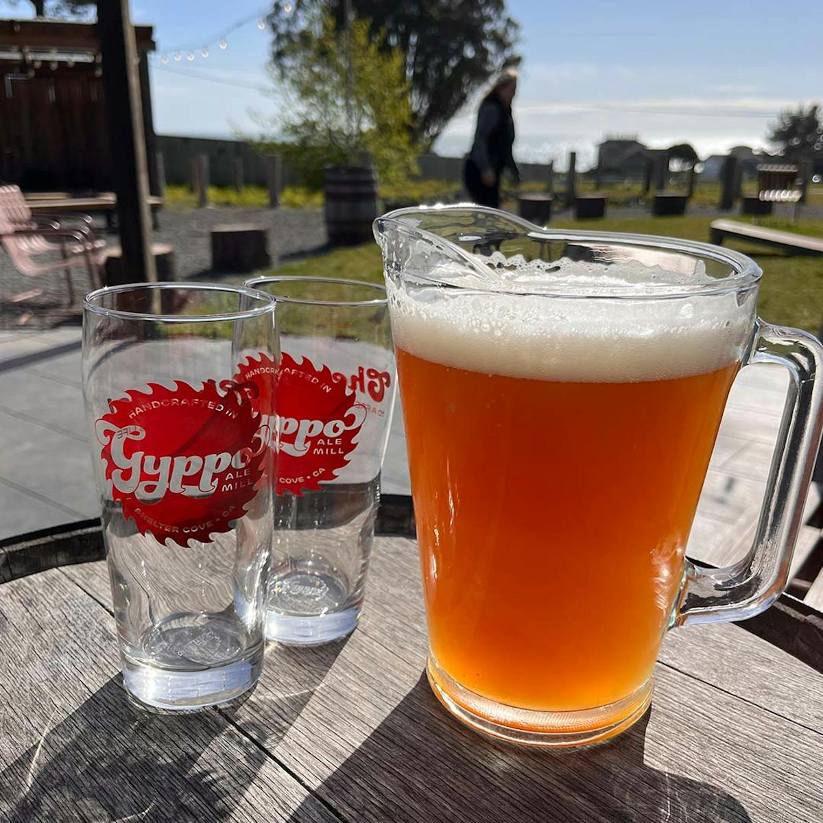 a glass of orange juice next to a cup of beer