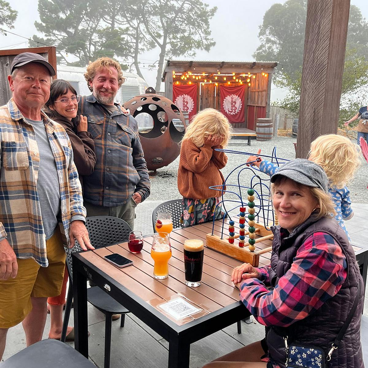 a group of people standing around a table
