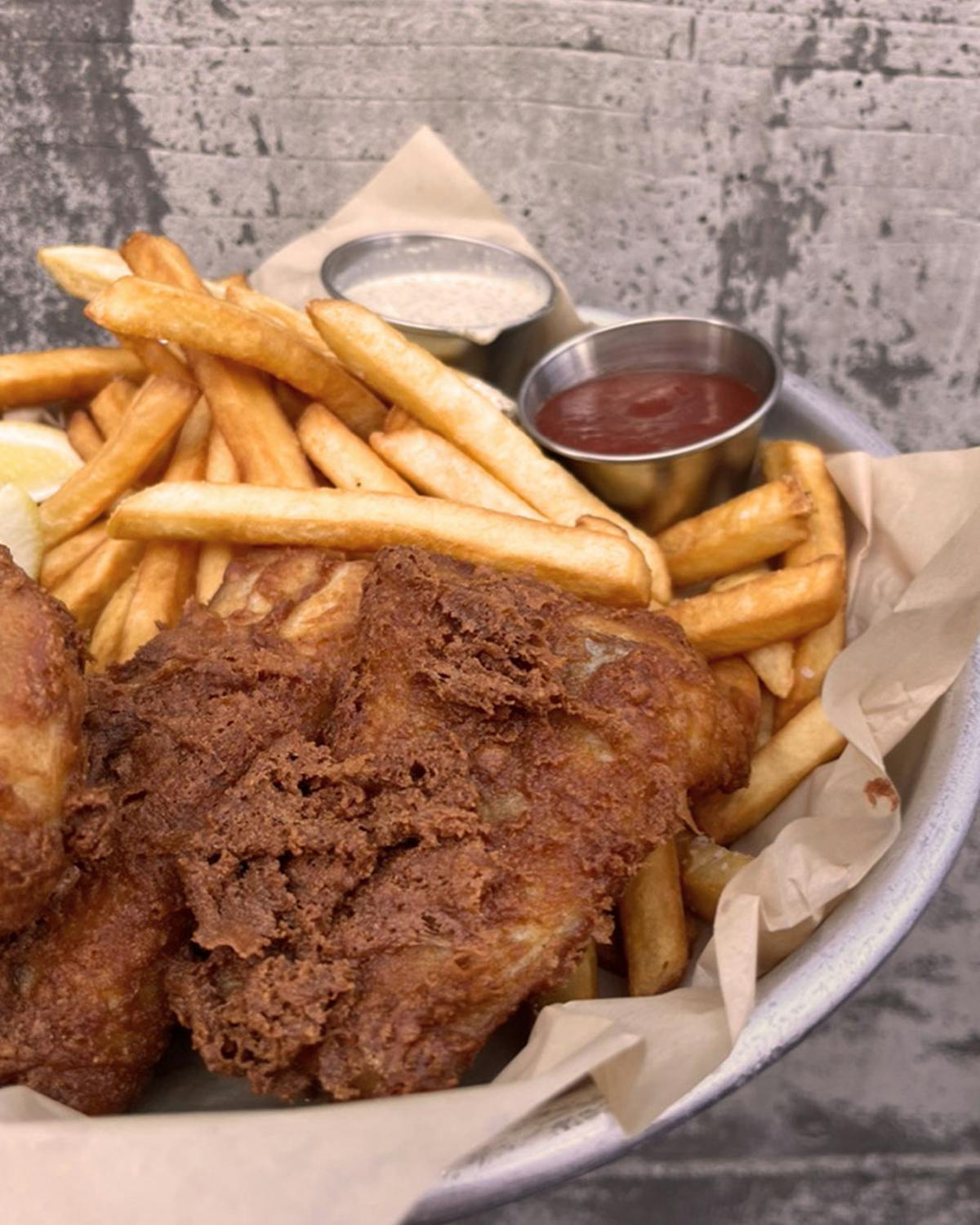 a sandwich sitting on top of a pile of fries