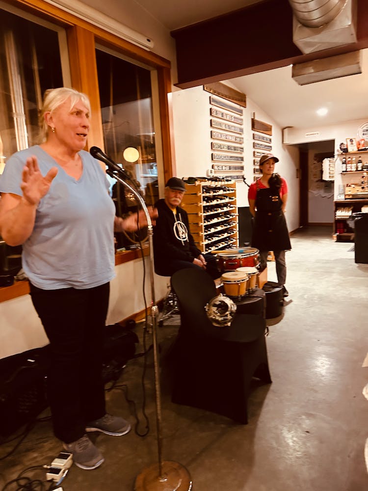 a woman standing in front of a microphone