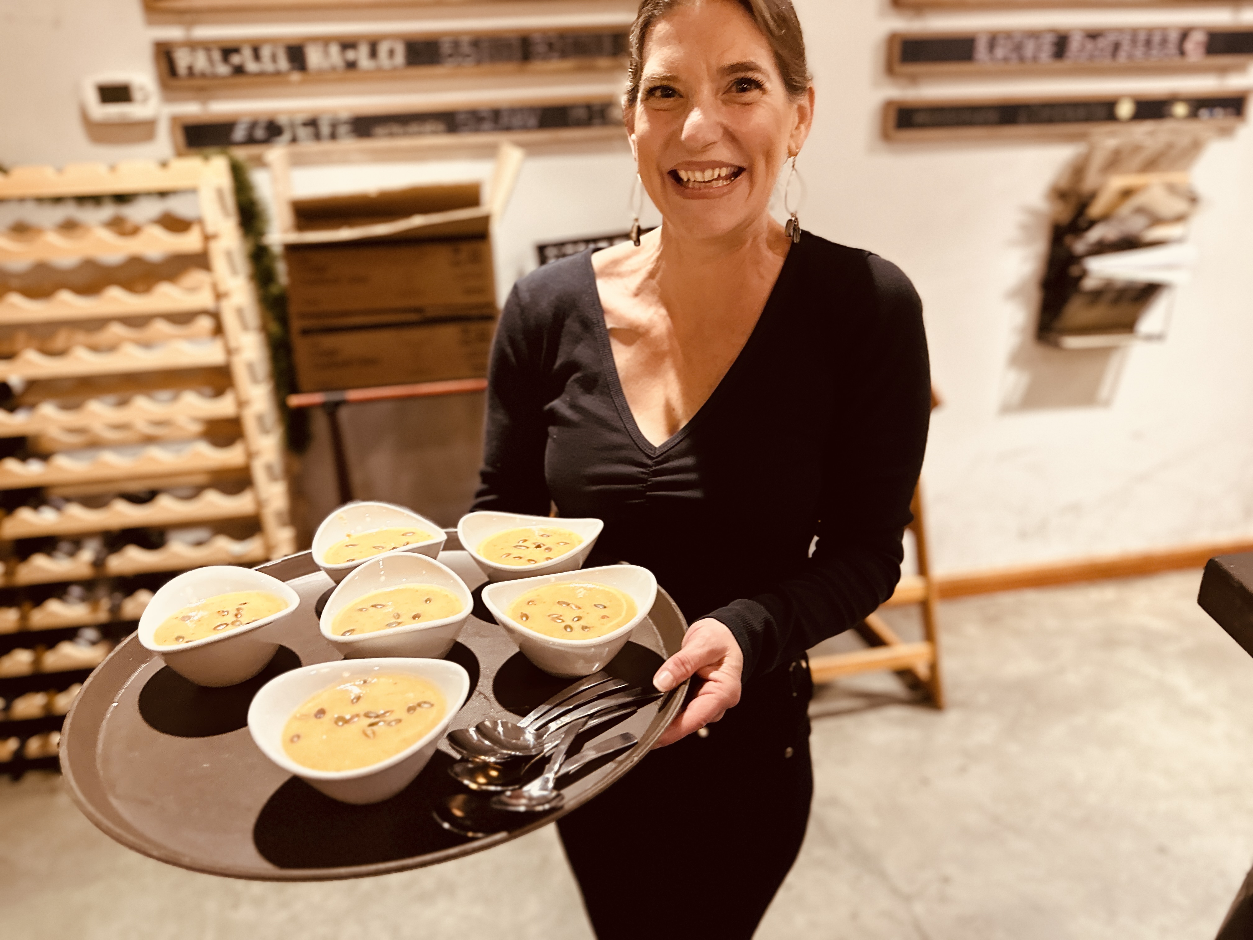 a woman sitting at a table with a plate of food