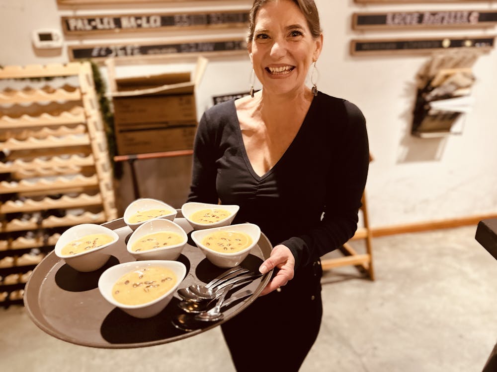 a woman sitting at a table with a plate of food