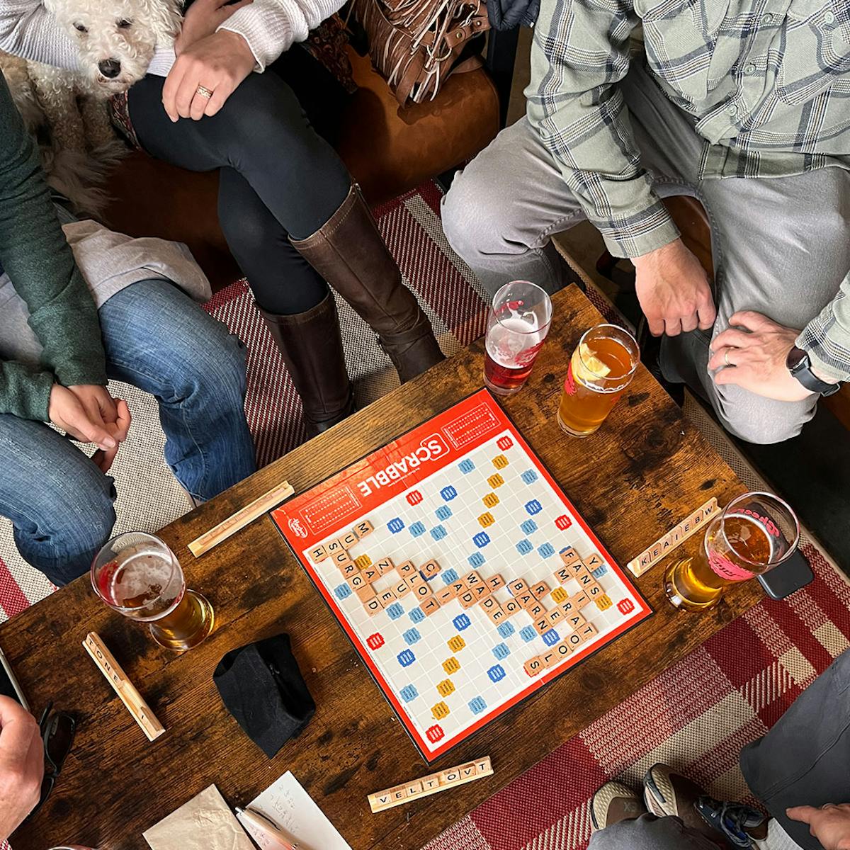a group of people sitting at a table with a cake