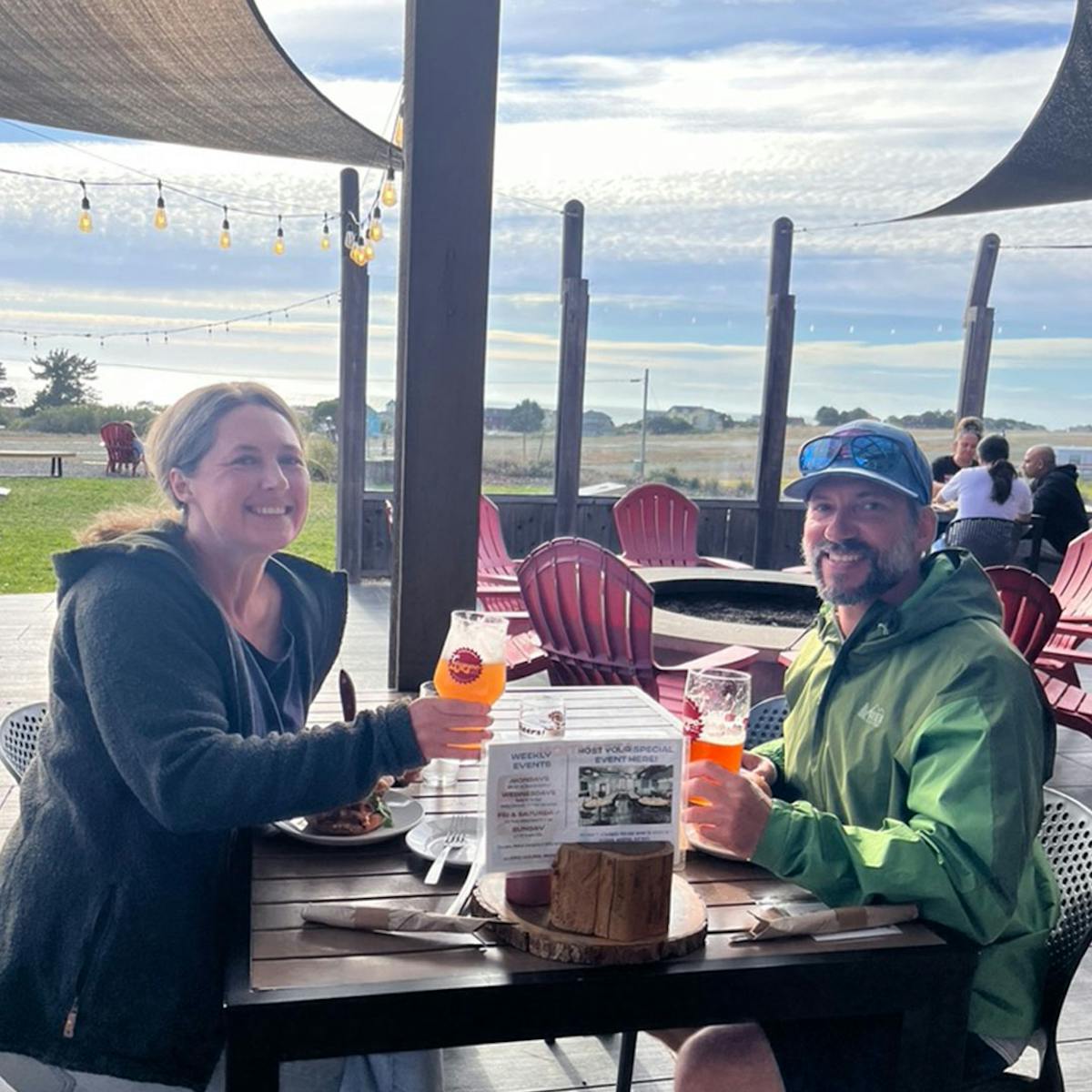 a group of people sitting at a picnic table