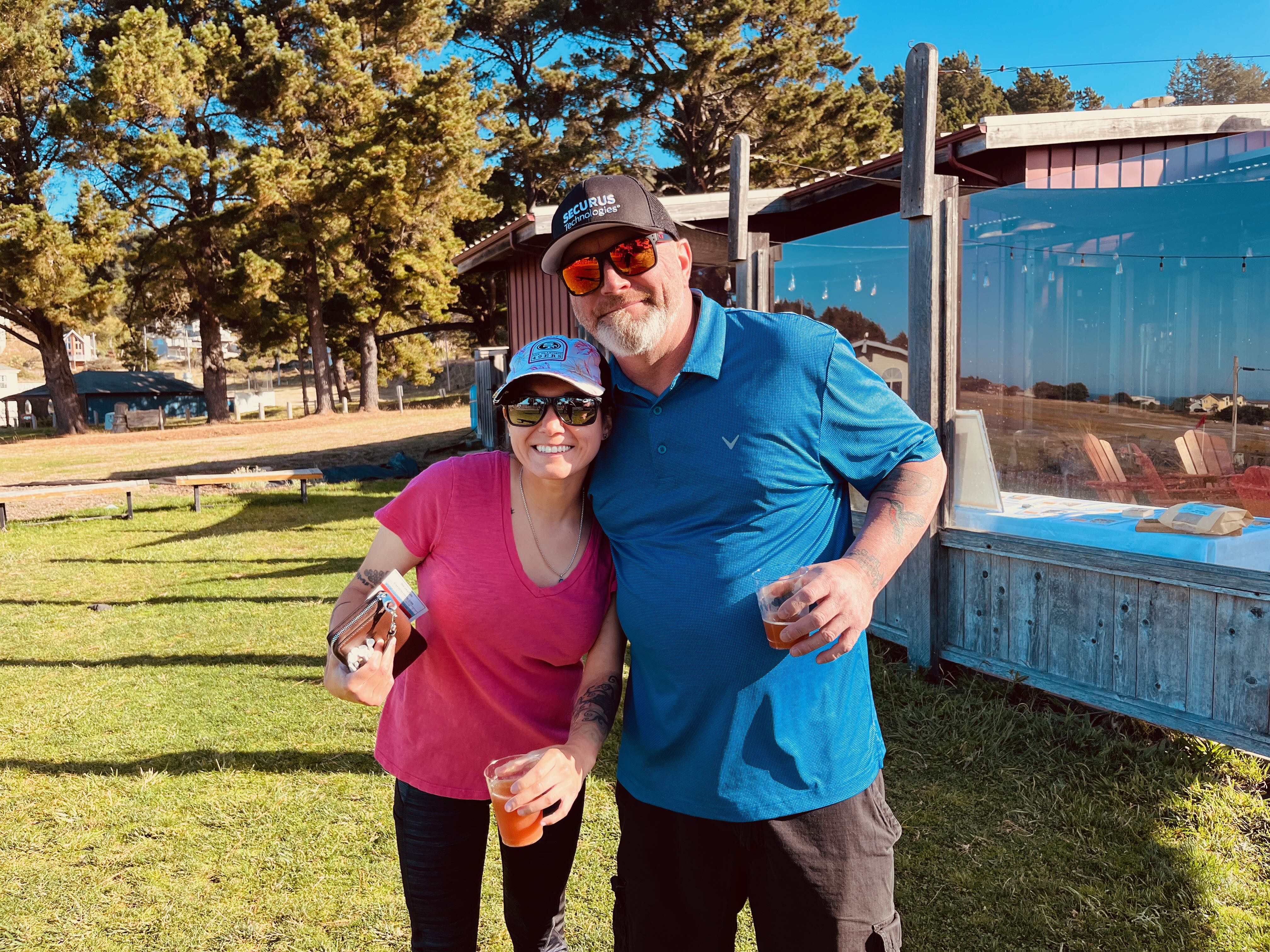 a man and woman standing together outside
