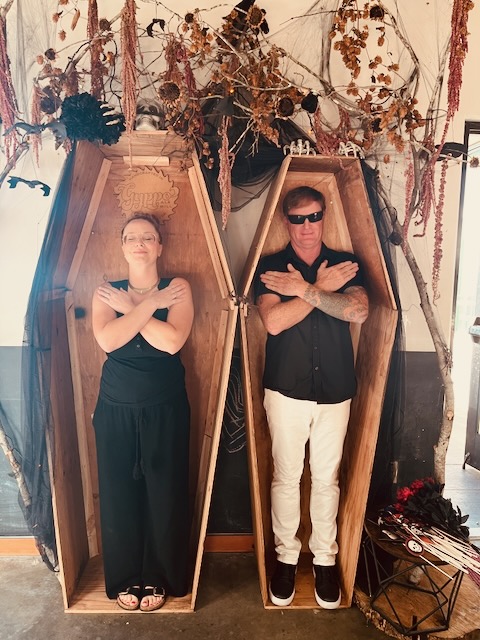 a man and woman in coffins