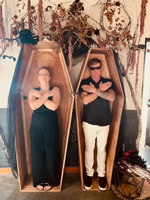 a man and woman in coffins