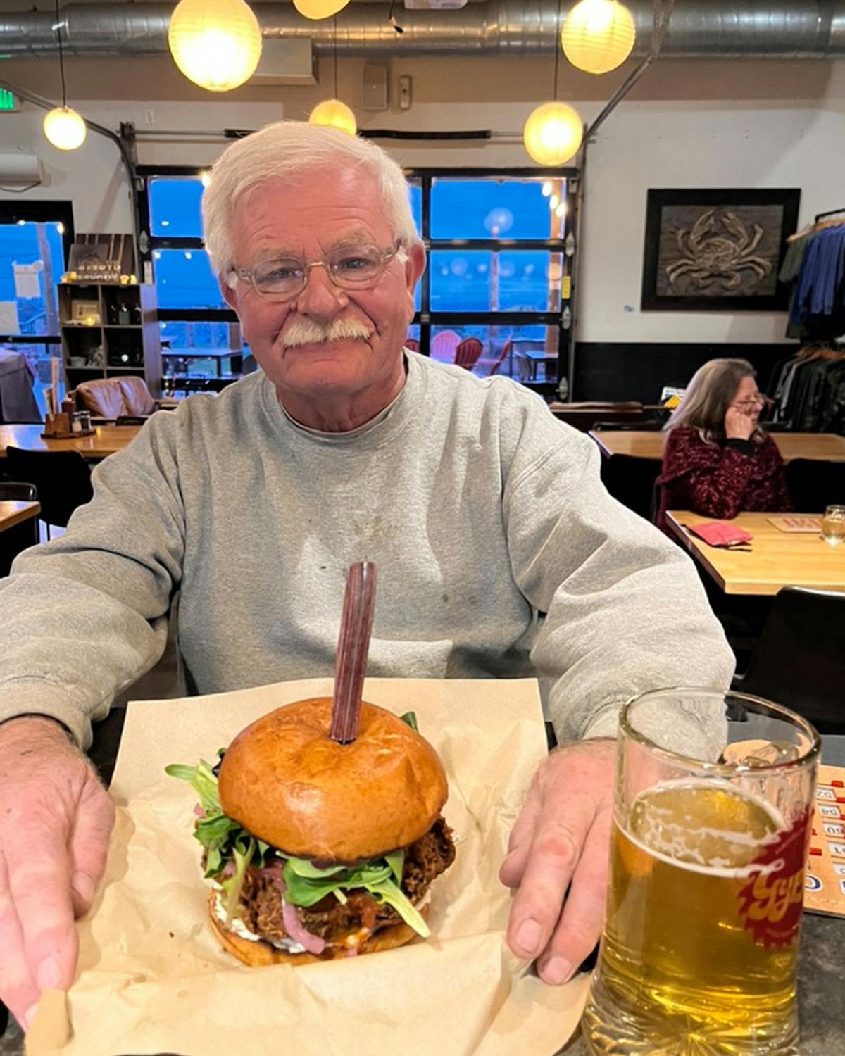 a man sitting at a table with a plate of food