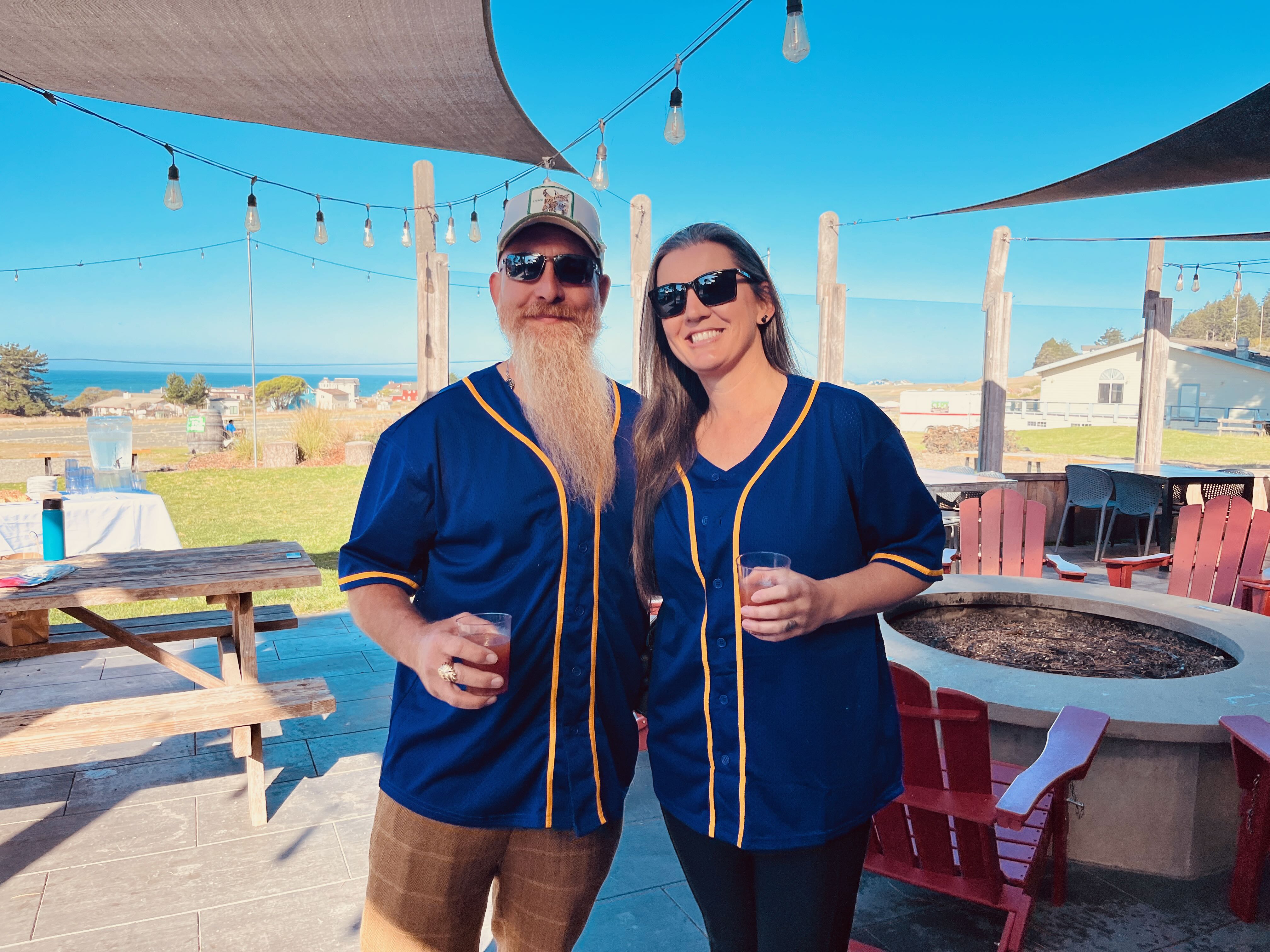 a man and woman wearing matching outfits