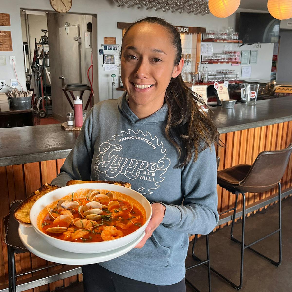 a person sitting at a table with a plate of food