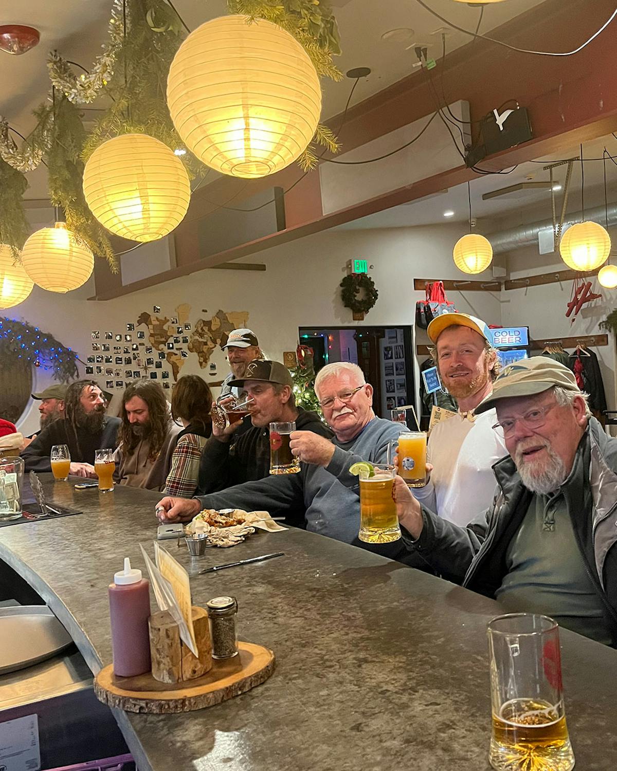 a group of people sitting at a table with wine glasses