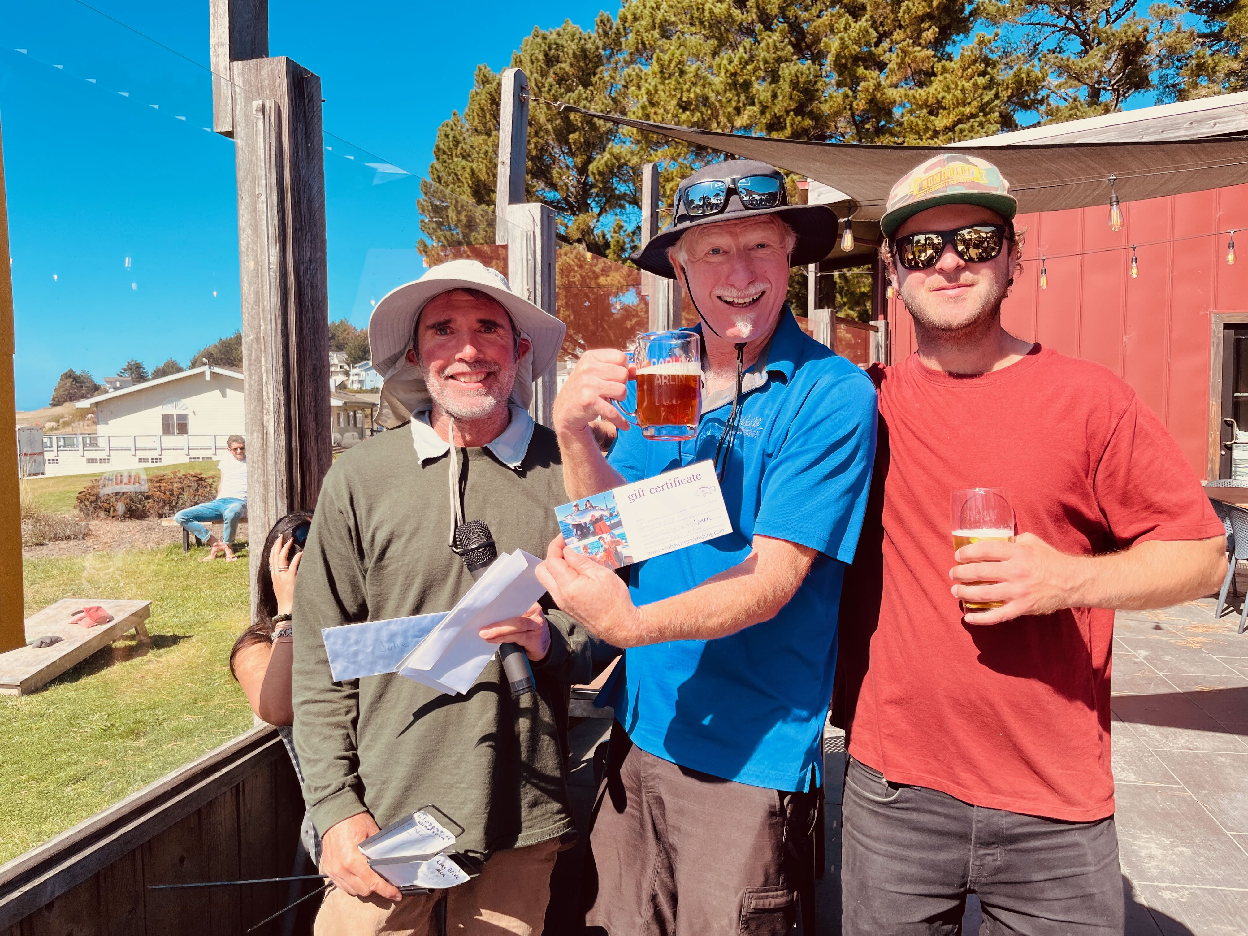 a group of men holding drinks and standing outside