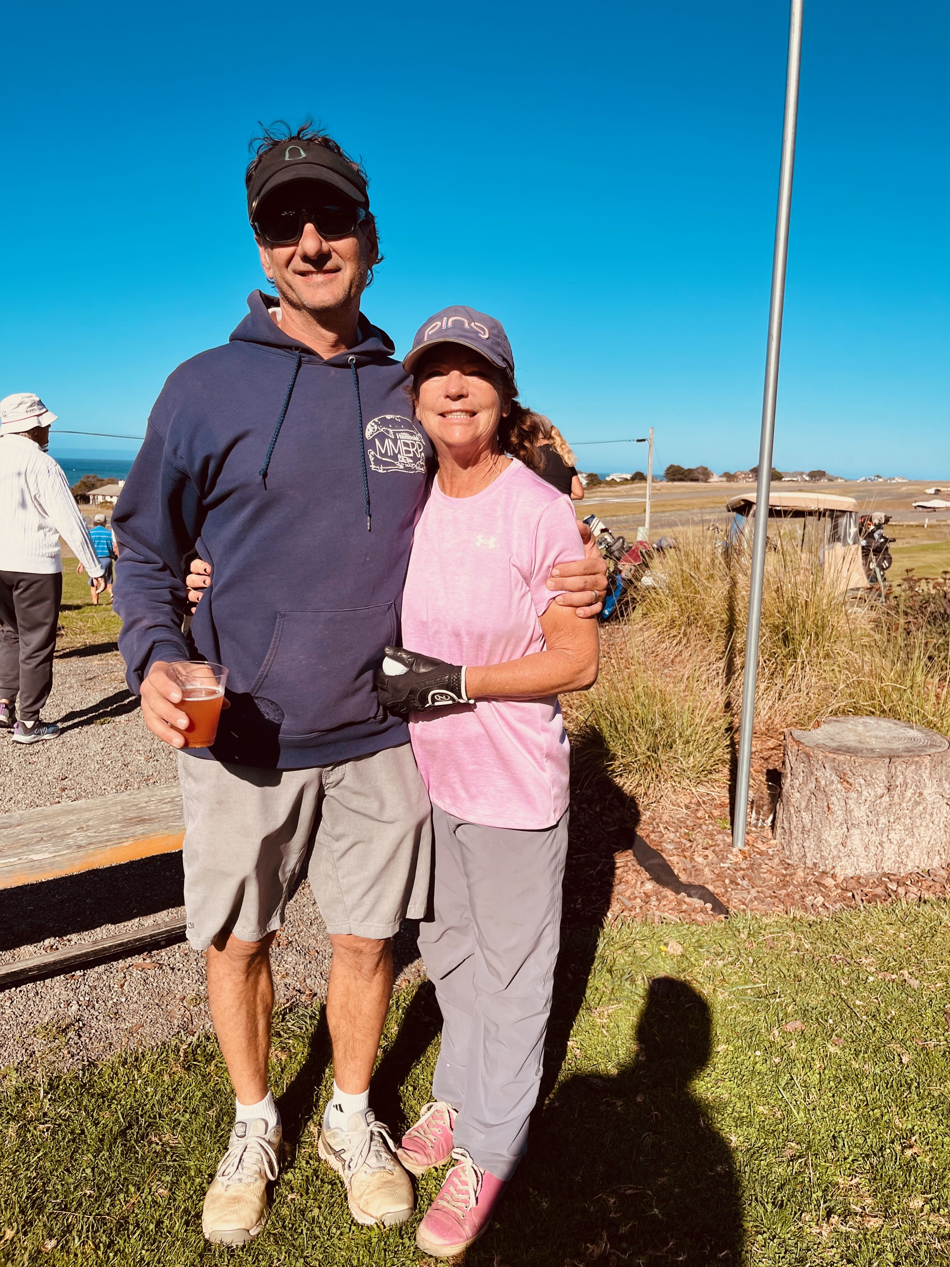 a man and woman standing together outside