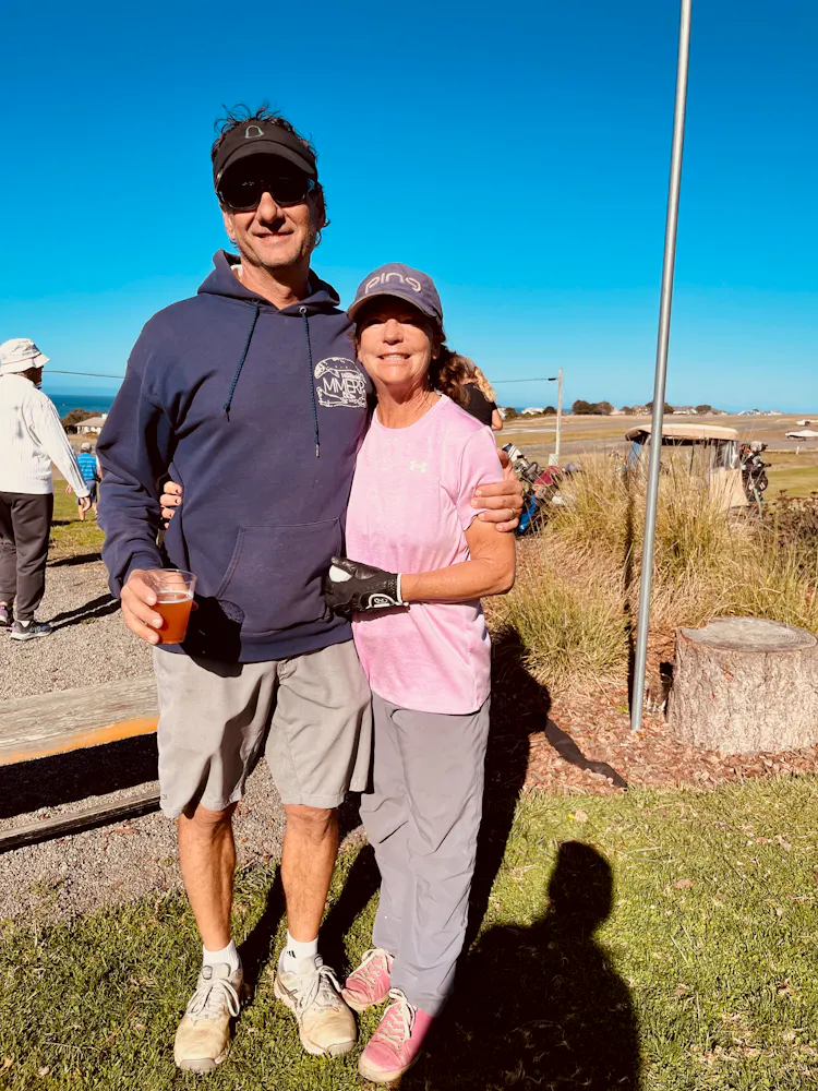 a man and woman standing together outside