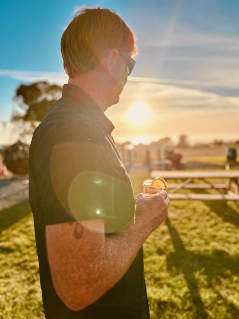 a man holding a drink in his hand