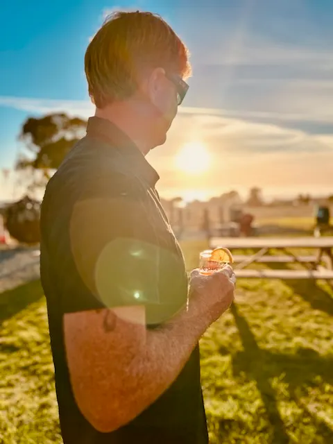 a man holding a drink in his hand
