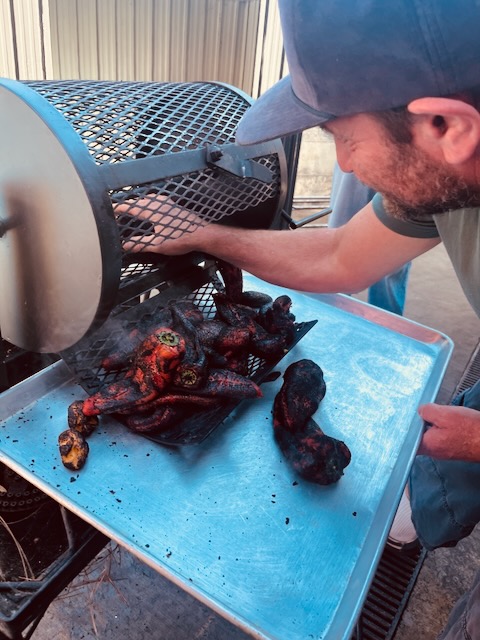 a man putting food into a grill
