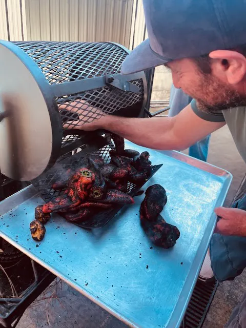 a man putting food into a grill