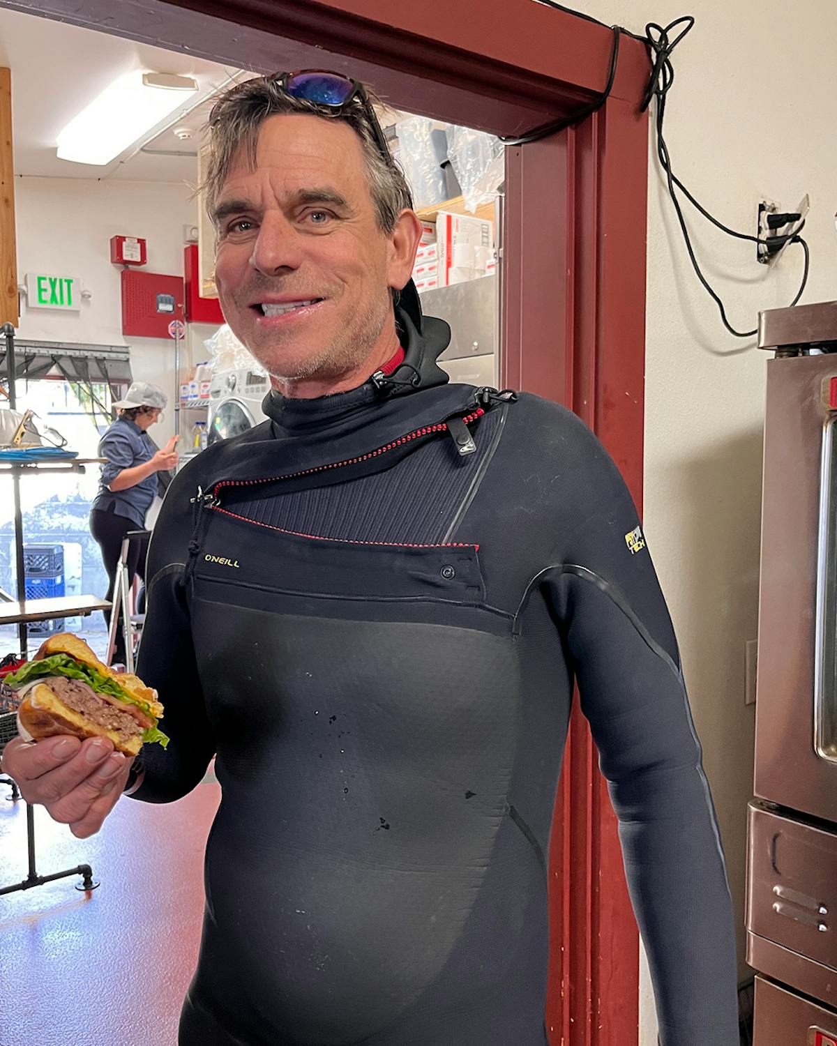 a man holding a sandwich in his hand