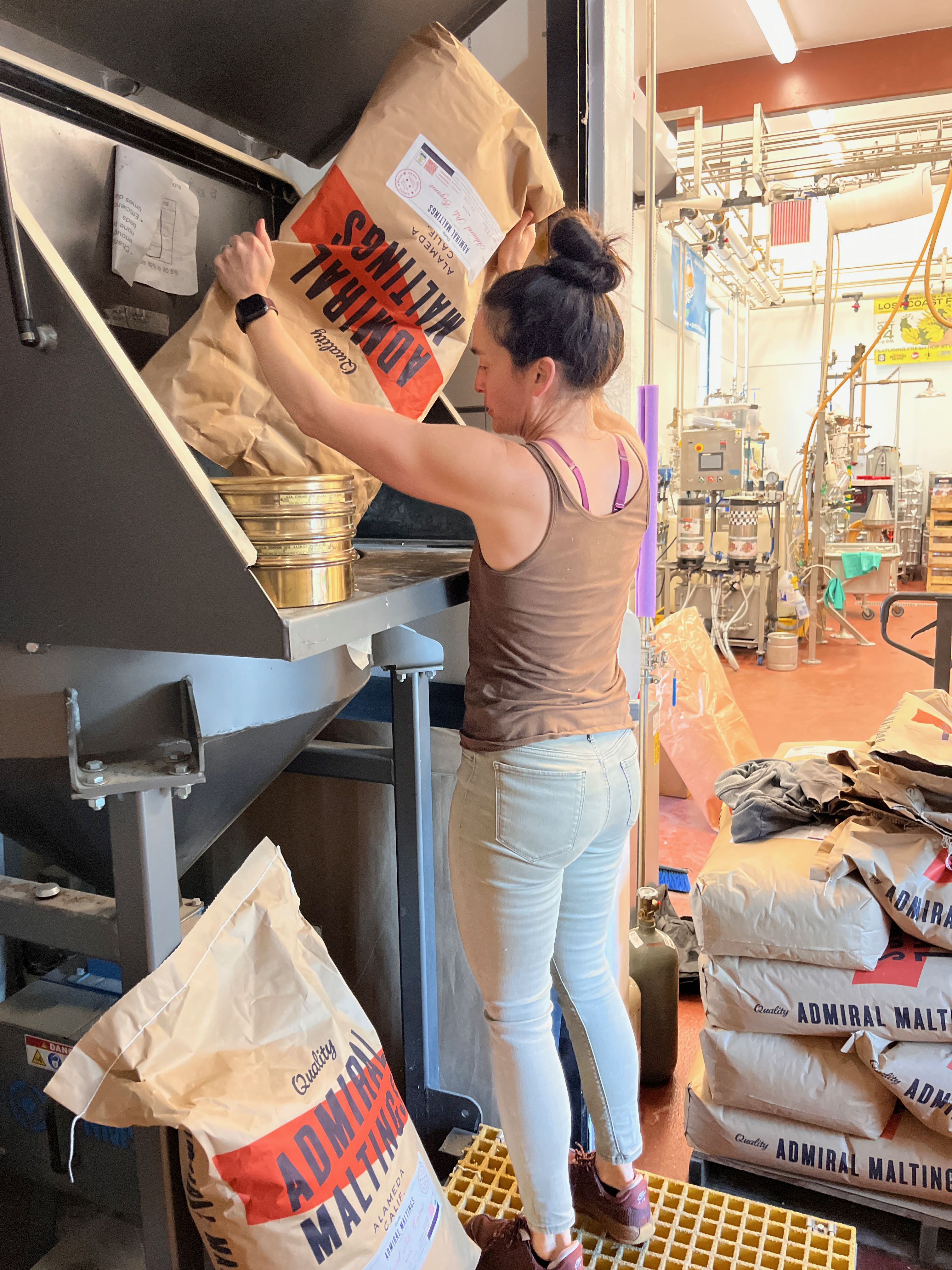 a woman putting a bag into a machine