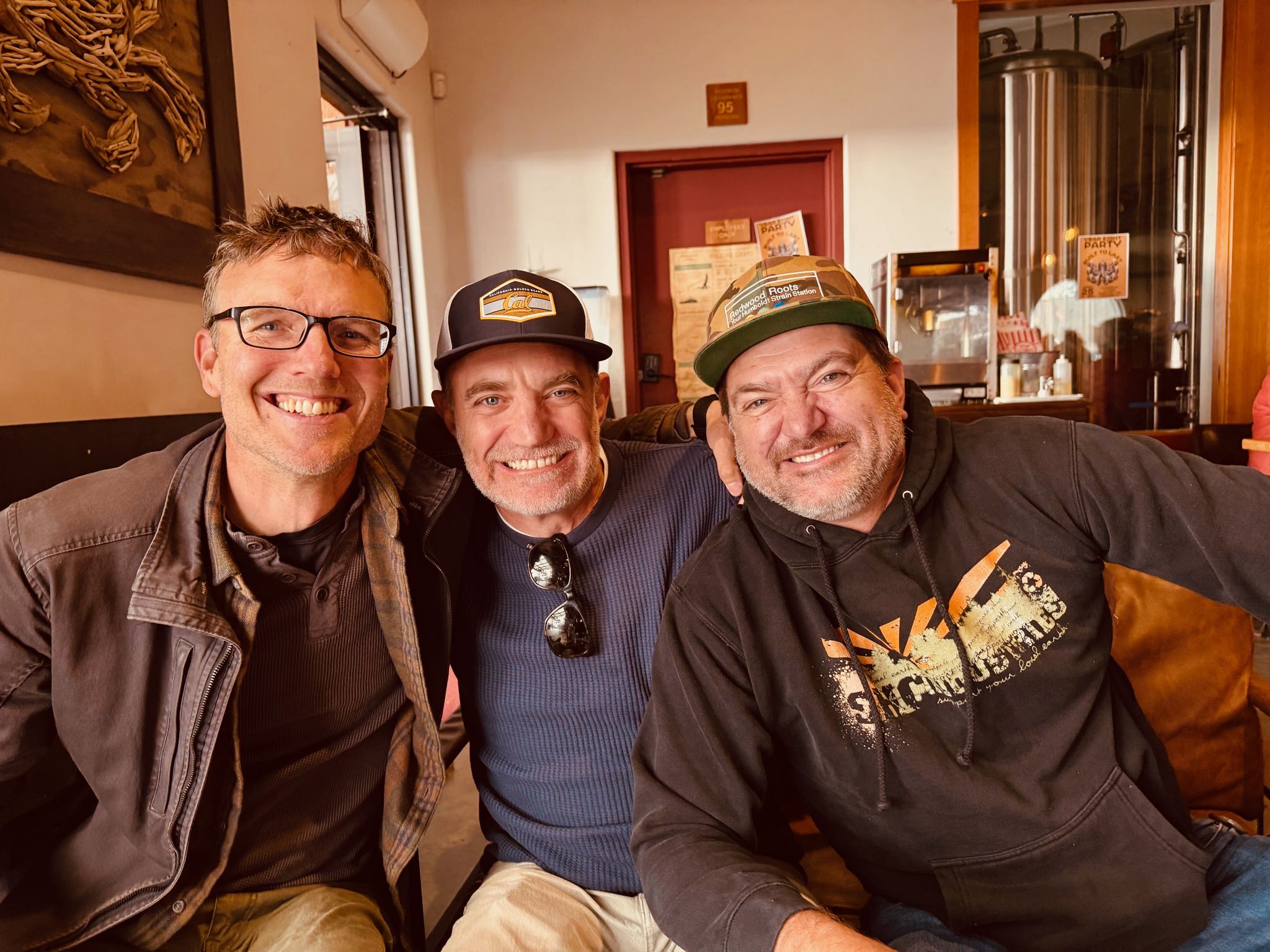 a group of men sitting together smiling