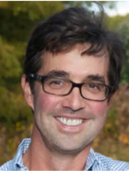 Photo of man smiling with glasses