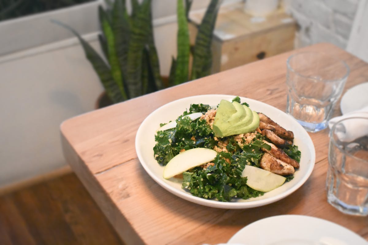 a plate of food sitting on top of a wooden table