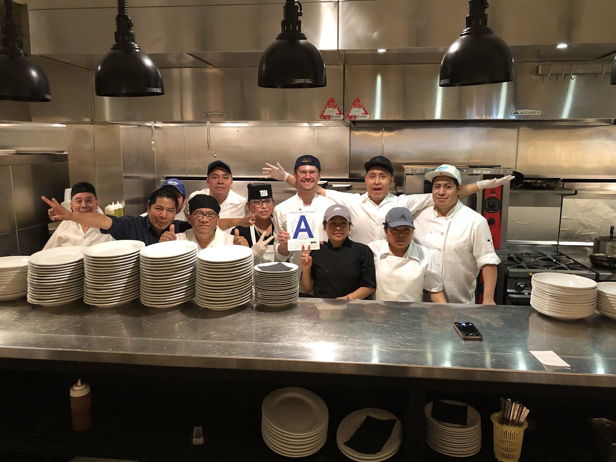 a group of people preparing food in a kitchen