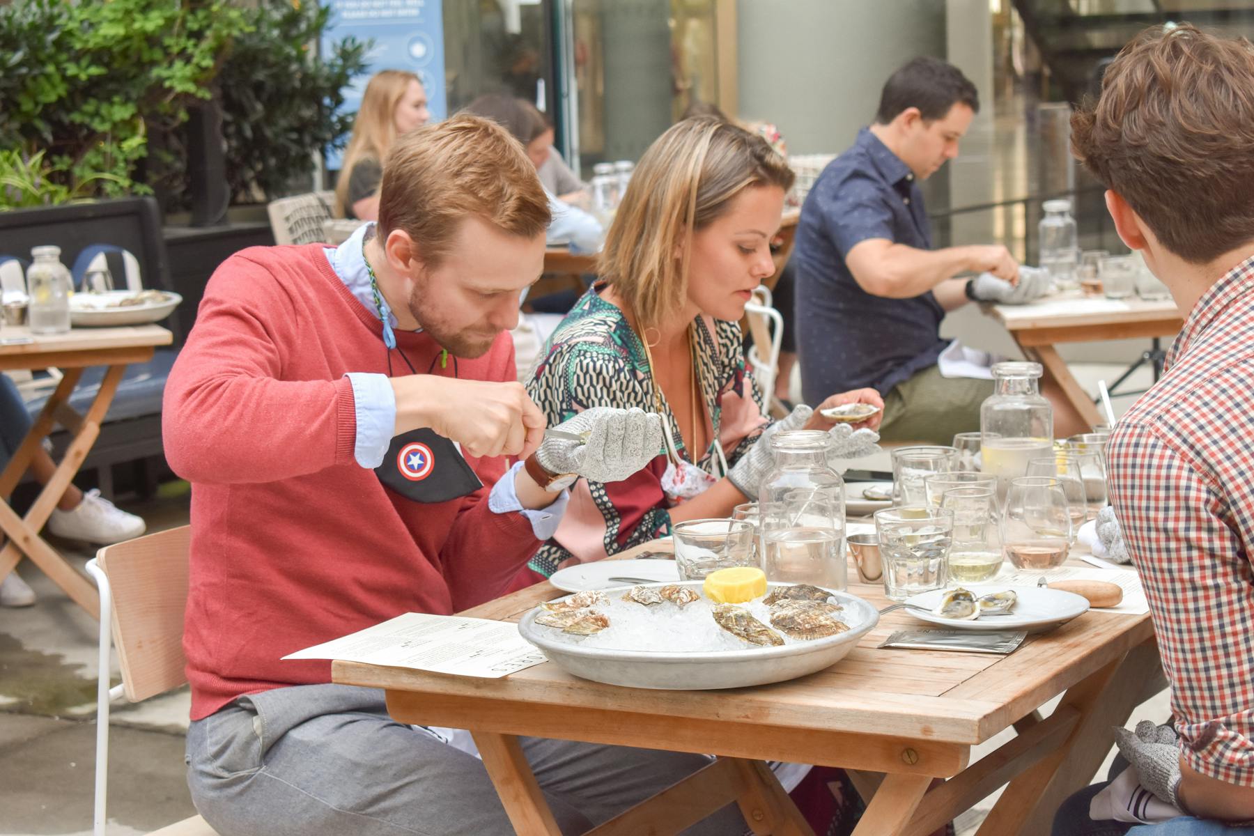 a group of people sitting at a table eating food