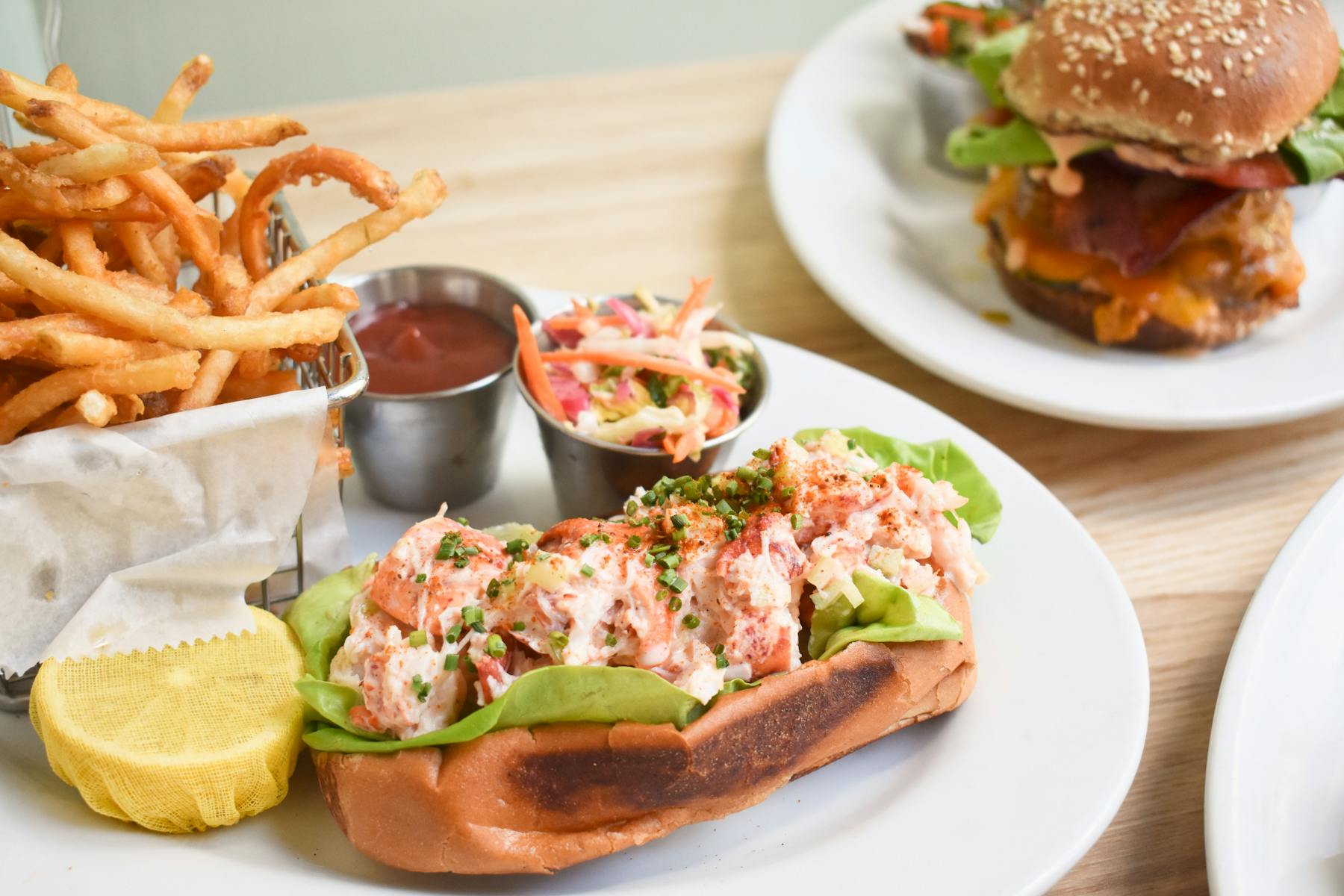 a close up of a sandwich and fries on a plate