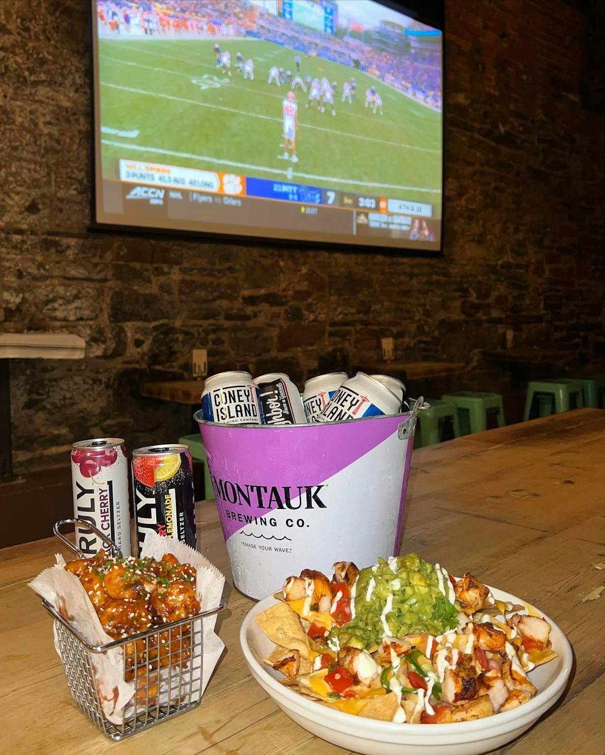 a plate of food on a table in front of a television