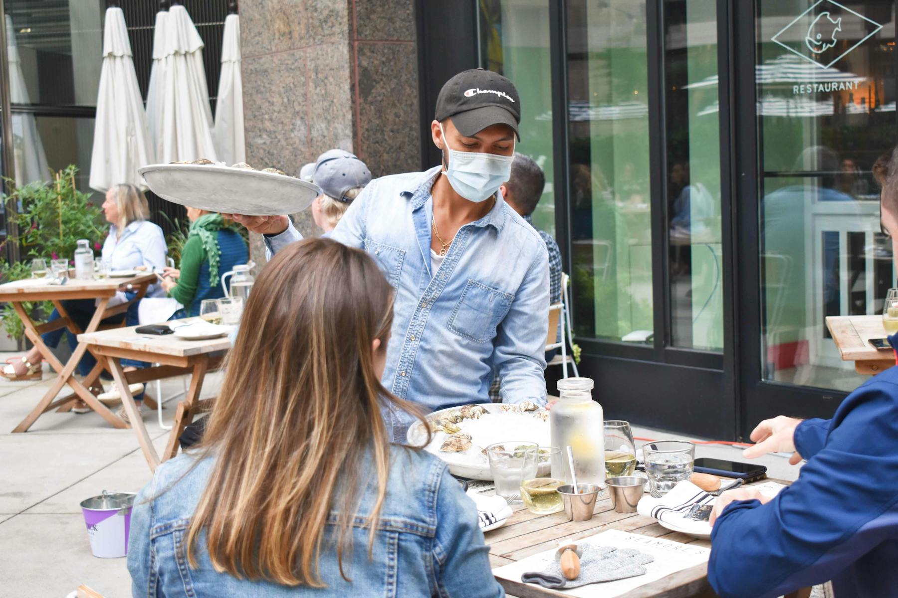 a group of people sitting at a table in a restaurant
