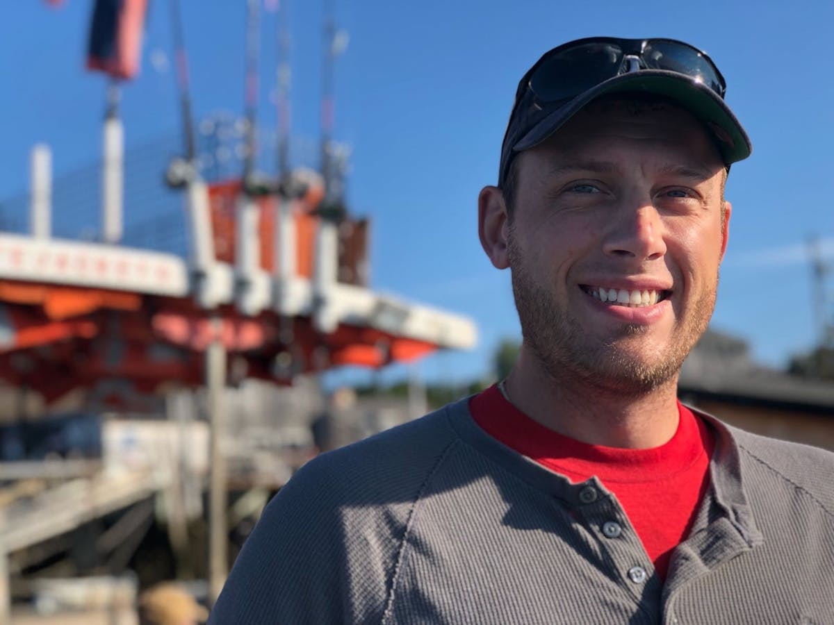 Photo of man wearing a hat on a fishing boat