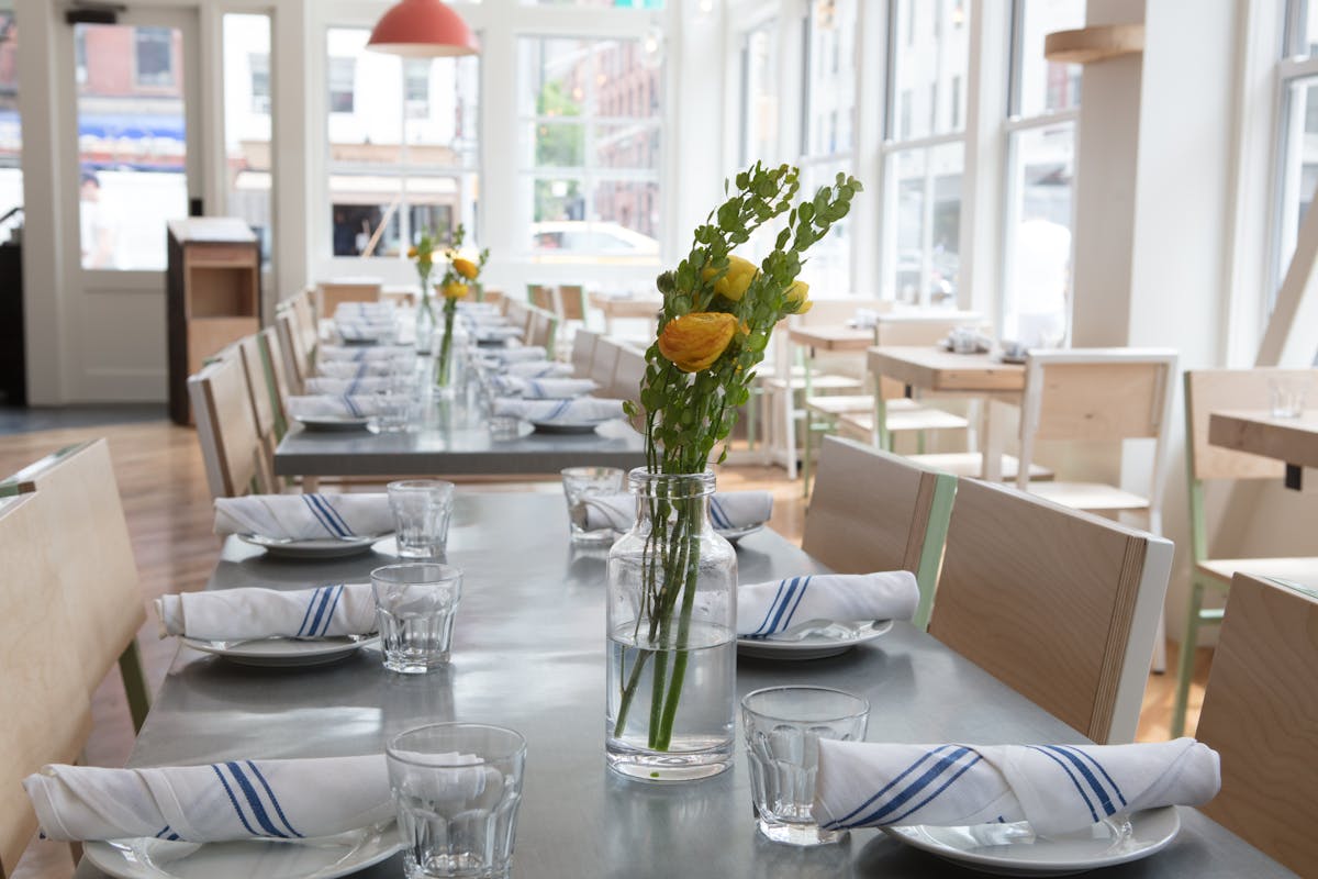 a dining room table in front of a window