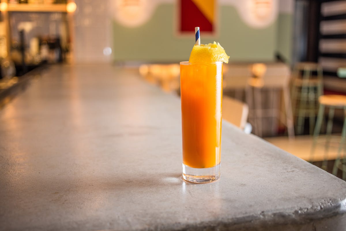 a close up of a glass of orange juice