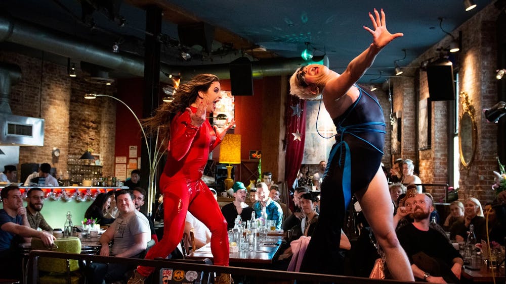 a group of people performing on stage in front of a building