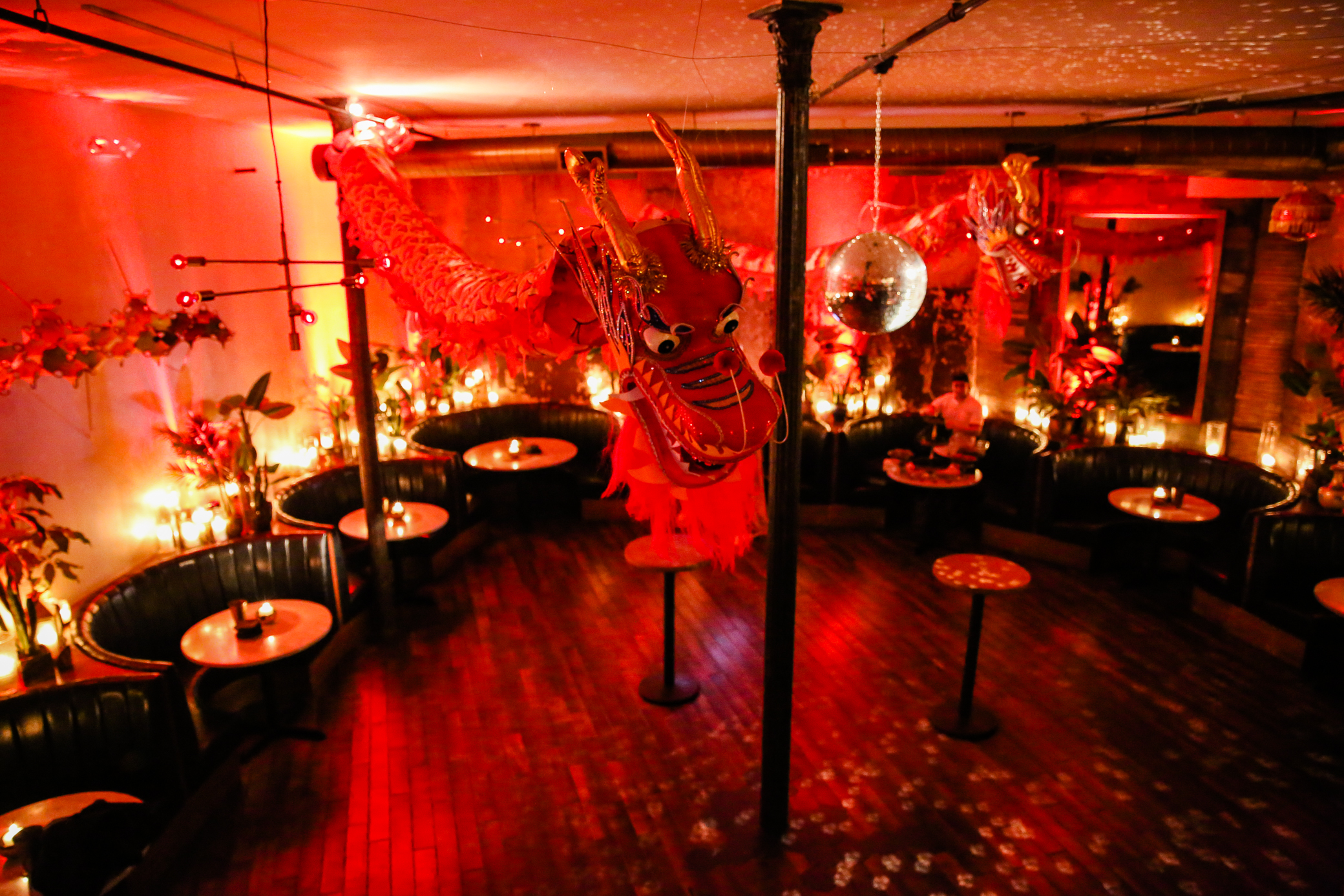 a group of men sitting at a table in a dark room