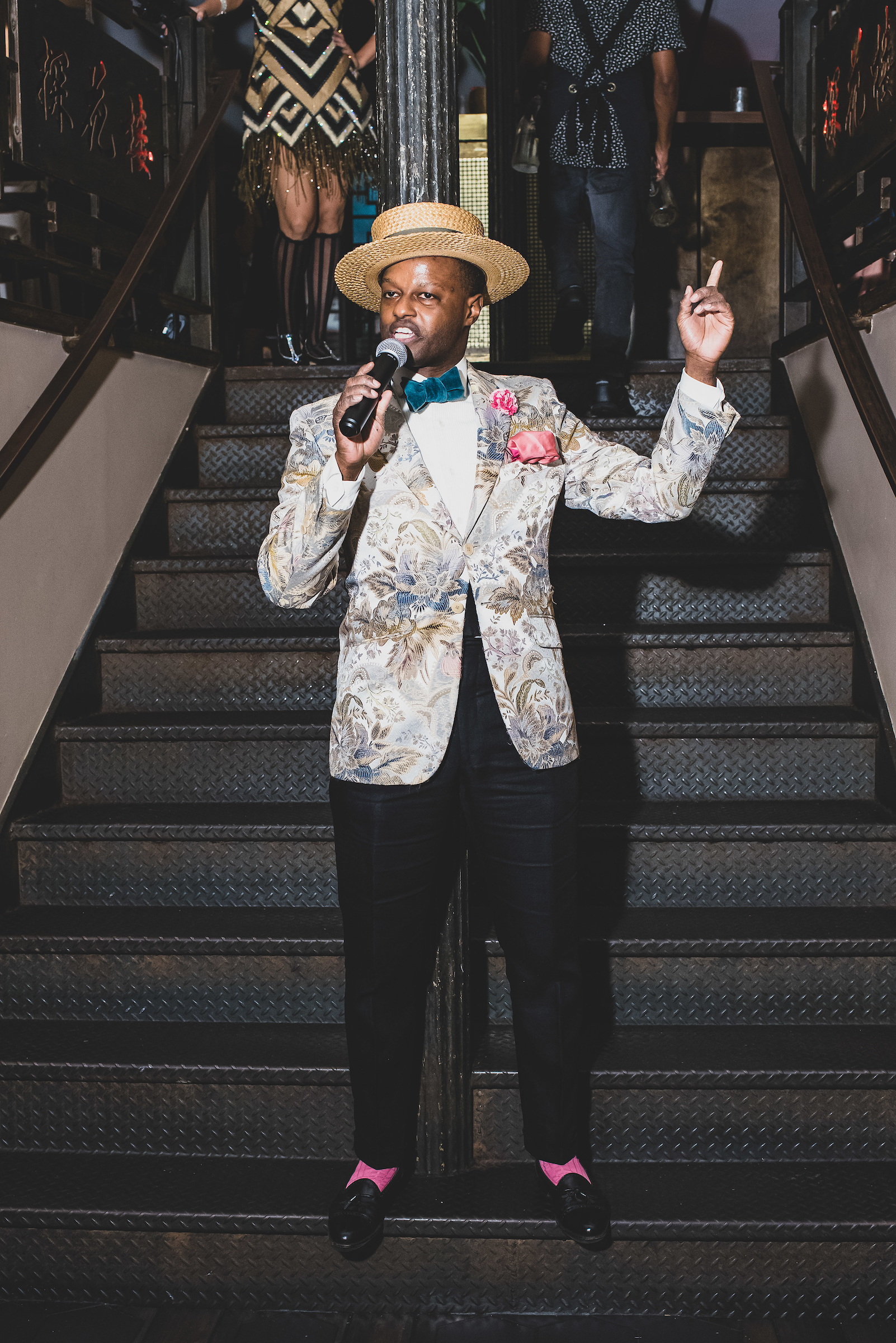 a person with a mic standing on the stairs